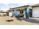 Covered back patio with comfortable seating and stylish blue curtains for privacy at 4617 E La Puente Ave, Phoenix, AZ 85044