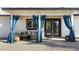 Inviting covered patio with stylish blue curtains, cozy seating, and easy access to the home at 4617 E La Puente Ave, Phoenix, AZ 85044