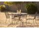 Charming backyard seating area with a round table, chairs, and outdoor games, perfect for gatherings at 4617 E La Puente Ave, Phoenix, AZ 85044
