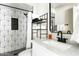 Modern bathroom featuring patterned tile shower, sleek black fixtures, and white marble countertop at 4617 E La Puente Ave, Phoenix, AZ 85044