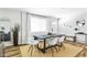 Sunlit dining area with modern table, seating for six, light-colored rug, and neutral paint colors at 4617 E La Puente Ave, Phoenix, AZ 85044