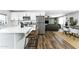 Open concept kitchen with white cabinetry, stainless appliances, quartz countertops, and open sightlines to the living room at 4617 E La Puente Ave, Phoenix, AZ 85044