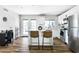 Modern kitchen with stainless steel appliances and breakfast bar seating at 4617 E La Puente Ave, Phoenix, AZ 85044