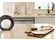 Up-close perspective of kitchen island with sleek design, white quartz countertop, and modern decorative elements and tableware at 4617 E La Puente Ave, Phoenix, AZ 85044