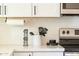 Clean, well-organized kitchen countertop featuring white quartz countertop and subway tile backsplash at 4617 E La Puente Ave, Phoenix, AZ 85044