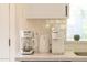 Well-appointed coffee and beverage station featuring coffee makers, a kettle, and coordinated white and stainless steel appliances at 4617 E La Puente Ave, Phoenix, AZ 85044