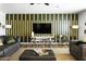 Stylish living room featuring a modern accent wall and comfortable seating at 4617 E La Puente Ave, Phoenix, AZ 85044