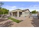 Desert-landscaped backyard featuring a covered patio, synthetic turf, and a seating area at 4665 E Dartmouth St, Mesa, AZ 85205