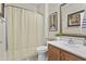 Cozy bathroom with a shower featuring a curtain, vanity, decorative mirror, and tiled floor at 4665 E Dartmouth St, Mesa, AZ 85205