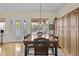 Spacious dining room with hardwood floors, a large table, and natural light at 4665 E Dartmouth St, Mesa, AZ 85205