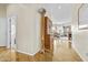 Bright hallway featuring hardwood floors, stylish decor, and an open view to the living area at 4665 E Dartmouth St, Mesa, AZ 85205