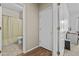 Hallway view showing access to a bathroom and additional rooms, with light hardwood flooring at 4665 E Dartmouth St, Mesa, AZ 85205