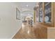 Inviting hallway with hardwood floors, archway, and built-in wooden display cabinet at 4665 E Dartmouth St, Mesa, AZ 85205