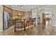 Gourmet kitchen featuring wooden cabinets, a stainless steel refrigerator, and bar seating at 4665 E Dartmouth St, Mesa, AZ 85205