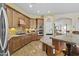 Well-lit kitchen with wood cabinets, granite countertops, and stainless steel appliances at 4665 E Dartmouth St, Mesa, AZ 85205