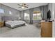 Spacious main bedroom with large windows, ceiling fan, plush carpet, and neutral decor at 4665 E Dartmouth St, Mesa, AZ 85205