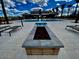 Resort-style pool with sun loungers, a fire pit, and a well-appointed clubhouse at 5747 E Star Valley St, Mesa, AZ 85215