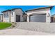 Beautiful home with gray doors, stone accents, a well-manicured lawn, and a brick driveway at 5747 E Star Valley St, Mesa, AZ 85215