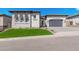 Beautiful single-Gathering home with stone accents, a well-manicured lawn, and a brick driveway at 5747 E Star Valley St, Mesa, AZ 85215