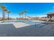 Community pool with palm trees and ample lounge seating under a clear blue sky at 5747 E Star Valley St, Mesa, AZ 85215