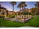 Expansive backyard with lush lawn, tall palm trees, and mountain views at 5902 E Arcadia Ln, Phoenix, AZ 85018