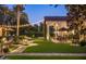Beautiful backyard with manicured lawn, patio area, and string lights at 5902 E Arcadia Ln, Phoenix, AZ 85018