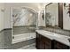 Elegant bathroom featuring marble shower, patterned tile, and dark wood vanity at 5902 E Arcadia Ln, Phoenix, AZ 85018