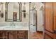 Bathroom featuring a vanity with marble countertop and a view into the shower at 5902 E Arcadia Ln, Phoenix, AZ 85018