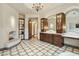 Expansive bathroom featuring a fireplace, vanities, and patterned tile flooring at 5902 E Arcadia Ln, Phoenix, AZ 85018
