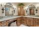 Stylish bathroom vanity featuring marble countertops, sconces, and custom cabinetry at 5902 E Arcadia Ln, Phoenix, AZ 85018