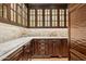 Charming butler's pantry with custom cabinets, marble countertops, and elegant design at 5902 E Arcadia Ln, Phoenix, AZ 85018