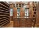 Spacious walk-in closet with custom shelving, cabinets, a ladder, and a central island at 5902 E Arcadia Ln, Phoenix, AZ 85018