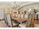 Elegant dining room featuring a large table, chandelier, and sophisticated decor at 5902 E Arcadia Ln, Phoenix, AZ 85018