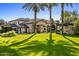 Stunning exterior view of a Mediterranean-style home with lush green lawn and mature trees at 5902 E Arcadia Ln, Phoenix, AZ 85018