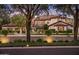 Elegant two-story home featuring a red tile roof, manicured landscaping, and stone accents against a mountain backdrop at 5902 E Arcadia Ln, Phoenix, AZ 85018