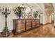 Hallway with beautiful wood floors, dresser, vases, and decorative artwork at 5902 E Arcadia Ln, Phoenix, AZ 85018
