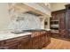 Gourmet kitchen with marble countertops, custom cabinetry, high-end range, and an ornate range hood at 5902 E Arcadia Ln, Phoenix, AZ 85018