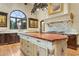 Gourmet kitchen with a large island, custom cabinetry, arched window, and high-end appliances at 5902 E Arcadia Ln, Phoenix, AZ 85018