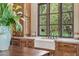 Charming kitchen sink beneath a window offering a view of a lush, lemon-filled garden at 5902 E Arcadia Ln, Phoenix, AZ 85018