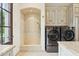 Well-equipped laundry room with modern washer, dryer, shower, and cabinetry at 5902 E Arcadia Ln, Phoenix, AZ 85018