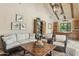 Cozy living room featuring a beamed ceiling, comfortable seating, and a stylish coffee table at 5902 E Arcadia Ln, Phoenix, AZ 85018