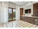 Entertainer's dream with gorgeous stone flooring, custom cabinets, bar area, and walk-out access to a private yard at 5902 E Arcadia Ln, Phoenix, AZ 85018
