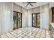 Bright living room with decorative tiled flooring, sheer curtains, recessed lighting, and double doors leading to the outdoor space at 5902 E Arcadia Ln, Phoenix, AZ 85018