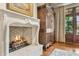 Cozy living room showcasing a stone fireplace with a roaring fire and an antique armoire at 5902 E Arcadia Ln, Phoenix, AZ 85018