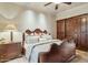 Elegant main bedroom with a decorative wooden bed frame and sconce lighting at 5902 E Arcadia Ln, Phoenix, AZ 85018