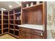 Spacious pantry with custom shelving and cabinets is perfect for storage and organization at 5902 E Arcadia Ln, Phoenix, AZ 85018