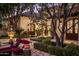 Landscaped patio with fountain, seating area, lush greenery, and a glimpse of the home's architecture at 5902 E Arcadia Ln, Phoenix, AZ 85018