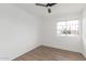 A bright bedroom features hardwood flooring, a ceiling fan, and a large window at 5939 W Cheery Lynn Rd, Phoenix, AZ 85033