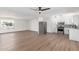 Open-concept living room and kitchen with stainless steel appliances and wood floors at 5939 W Cheery Lynn Rd, Phoenix, AZ 85033