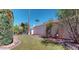 Beautiful backyard with lush greenery, a paved path, and manicured landscaping at 6720 W Mcrae Way, Glendale, AZ 85308